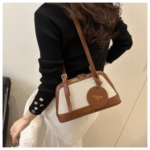 Detail of vintage canvas and leather patchwork boston bag with adjustable shoulder strap
