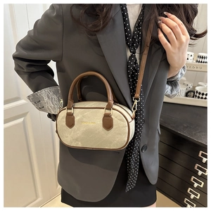 Detail of small retro bowling bag with fashion & bags text and leather trim shoulder strap