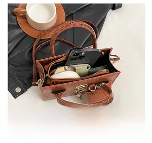 Detail view of the brown crocodile pattern handbag interior showing daily storage capacity