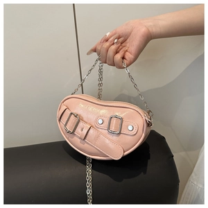 Detailed view of a pink heart-shaped bag with silver chain and buckle accents
