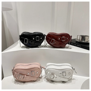 Detail of heart-shaped crossbody bags with glossy PU finish and metal chain straps