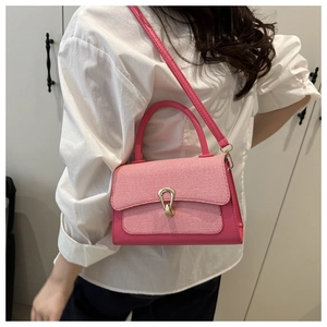 Detailed view of pink crossbody bag on model showing size ratio and fabric texture