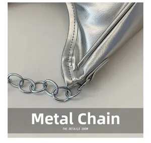 Close-up of shiny silver hardware chain and textured faux leather on a shoulder bag