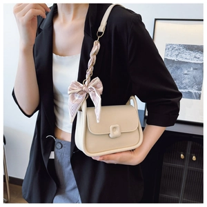 Chic beige crossbody square bag with a striped silk scarf bow detail on the strap