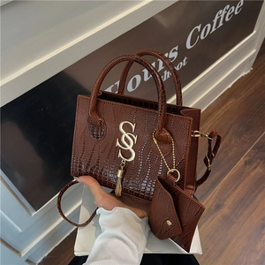 Deep brown crocodile pattern handbag with SS logo, tassel, and small coin purse strap