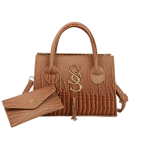 Brown crocodile pattern faux leather handbag set with gold letter logo and tassel detail
