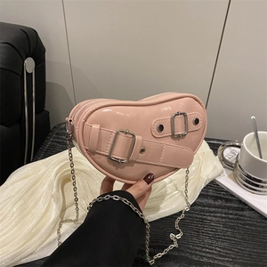 Chic pink heart-shaped shoulder bag with glossy finish and stylish silver chain strap