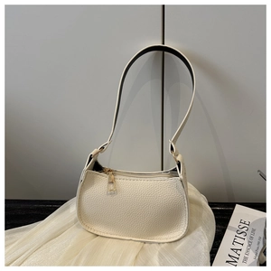Close-up of cream lychee texture faux leather bag with gold metal zipper detail