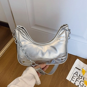Silver crescent underarm bag with thick metallic chain and leather strap
