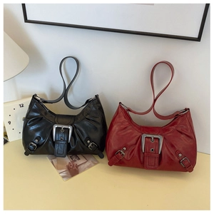 Detail of vintage hobo shoulder bags in black and deep red with large silver metal buckles