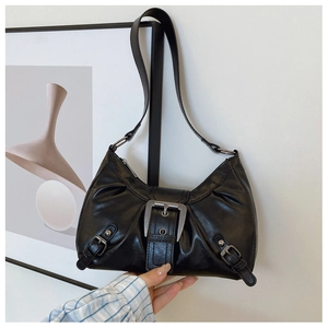 Detail of black retro crescent shoulder bag featuring silver metal buckle and biker style