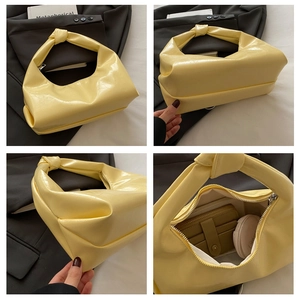 Macro details of the bright yellow glossy crescent bag showing internal storage and knotted handle