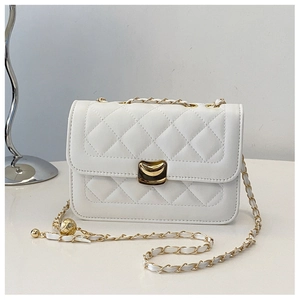 Close-up of white quilted leather bag with golden crescent lock and chain strap