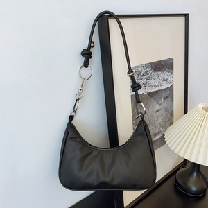 Minimalist black crescent shoulder bag with leather finish and metallic ring detail
