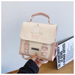 Detail of pink and beige patchwork crossbody bag with cute cartoon bear and buckle decor