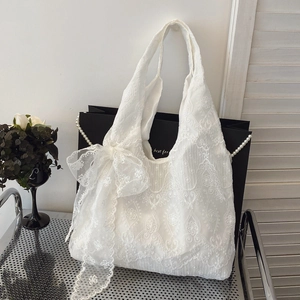Elegant white lace tote bag with floral embroidery and a large decorative side bow