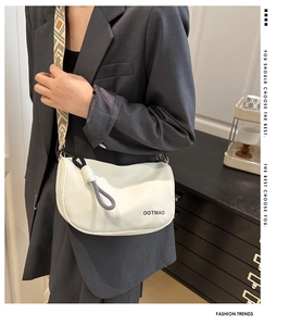 Detail of off-white Boston bag with a geometric ethnic style woven wide shoulder strap