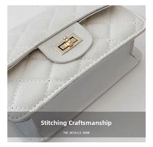 Close-up of white quilted leather bag showing precise stitching and golden twist lock