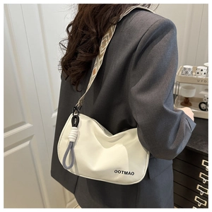 Chic beige crescent crossbody bag with a geometric diamond pattern wide shoulder strap