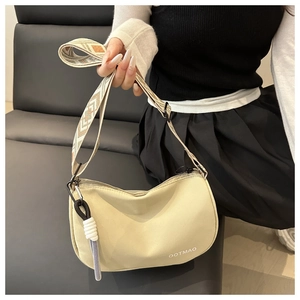 Detail of cream nylon crescent bag with wide geometric strap and OOTMAO logo