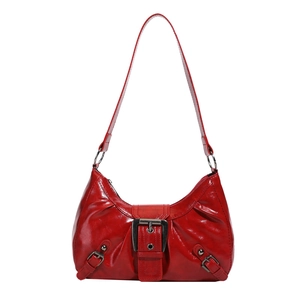 Red glossy leather underarm bag with large metal buckle in retro vintage style