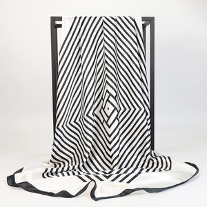 Macro detail of high-quality silk scarf with black and white geometric striped patterns