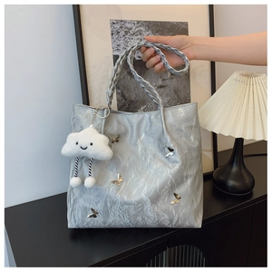 Silver metallic tote bag featuring 3D butterfly hardware and a cute cloud plush charm