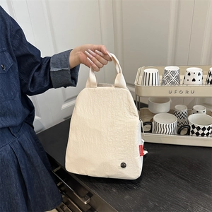 Sac à main polyvalent en tissu blanc cassé avec poignées et étiquette de mode rouge