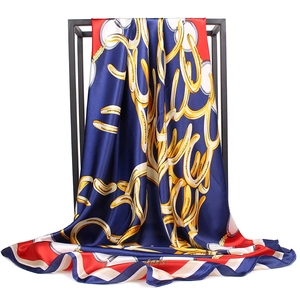Close-up of nautical chain print scarf on black rack with elegant draping and silky texture