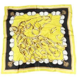 Detail of equestrian satin scarf with yellow horse head print and chain patterns