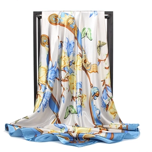 Elegant 90cm satin silk scarf with ivory base, blue floral prints, and golden scroll motifs