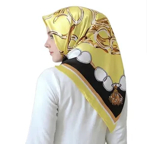 Elegant 90cm yellow satin headscarf featuring gold chain and tassel print patterns