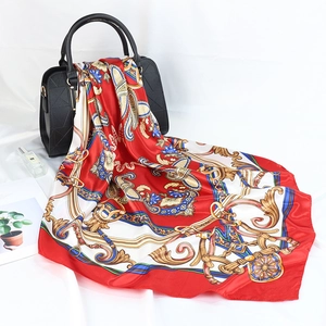 Elegant 90cm red satin silk scarf with vintage paisley print draped on a black handbag