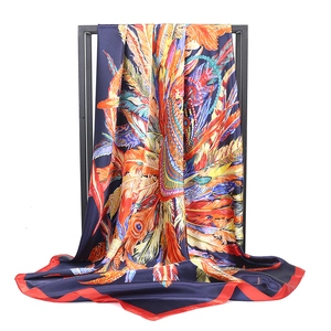Luxurious 90x90cm navy blue silk scarf featuring colorful peacock feather prints