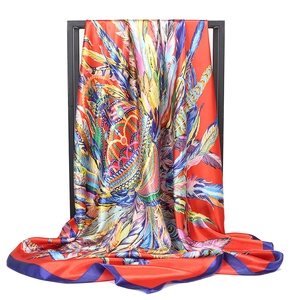 Satin silk scarf featuring a vibrant red base with luxury feather and bead prints