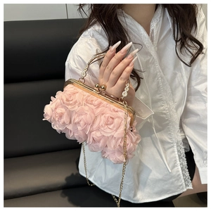 Detail of pink chiffon 3D floral evening bag with gold handle and pearl chain