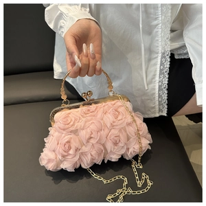 Detailed shot of pink chiffon floral evening bag with gold chain and metal handle