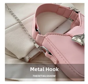 Detailansicht der silbernen Metallhaken und Kettenverbindung an der rosa Tasche