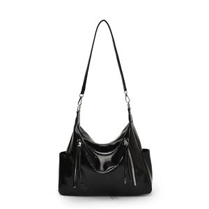 Glossy black tote bag with silver zippers and adjustable strap on white background
