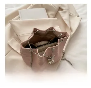 Internal capacity of pink drawstring bucket bag with phone and pearl rabbit charm