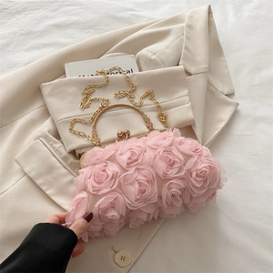 Detail of pink 3D rose flower handbag with gold metal handle and chain strap