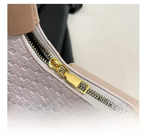 Detailed macro view of woven texture with pink leather trim and gold zipper design