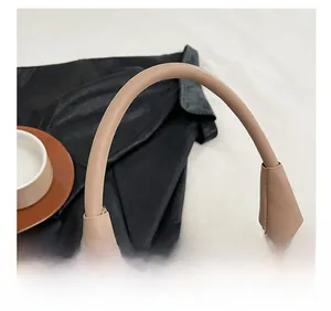 Detail show of woven texture purple bag with beige leather handle and smooth metal zipper