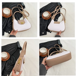 Detailed views of checkered crescent underarm bag with gold lock and leather accents