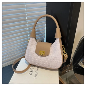 Detail of white woven bag with khaki leather flap and elegant gold rotating lock