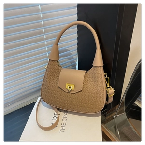 Detailed view of beige woven leather hobo bag with a golden square twist lock buckle