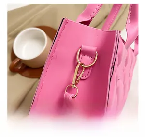Detail of pink quilted PU leather bag showing gold D-ring and lobster clasp hardware