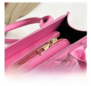 Close-up of pink quilted PU leather handbag with high-quality gold metal zipper details