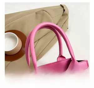 Detailed view of pink quilted PU leather handbag with precision stitching and round handle