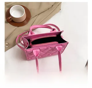 Detail showing the pink quilted handbag interior with a practical zipped compartment